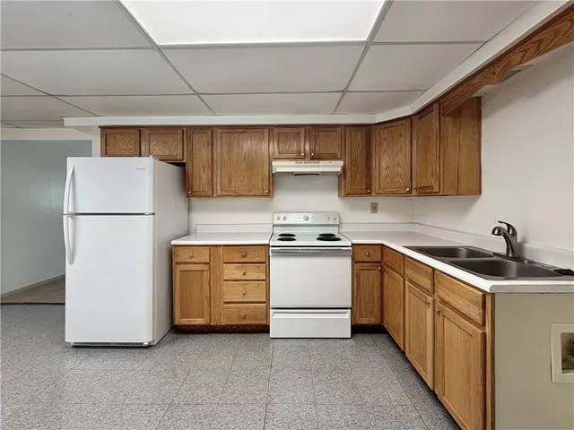 a kitchen with white cabinets and white appliances
