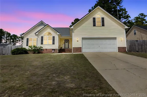 a front view of a house with a yard and garage