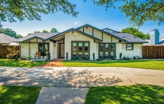 a front view of a house with a yard and porch