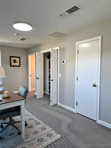 a view of a livingroom with workspace and a couch