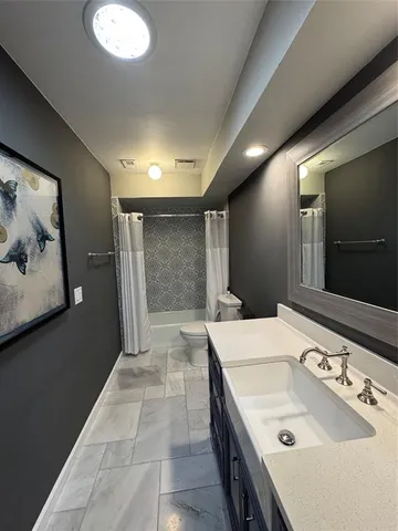 a living room with wooden floors and a fireplace