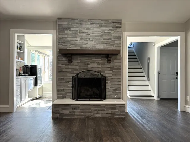a view of a livingroom with wooden floor and window