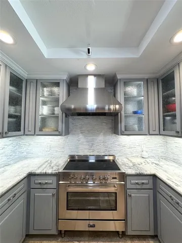 a stove top oven sitting inside of a kitchen