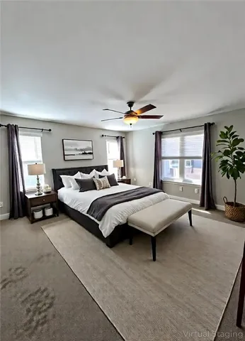 a bedroom with a bed and large windows