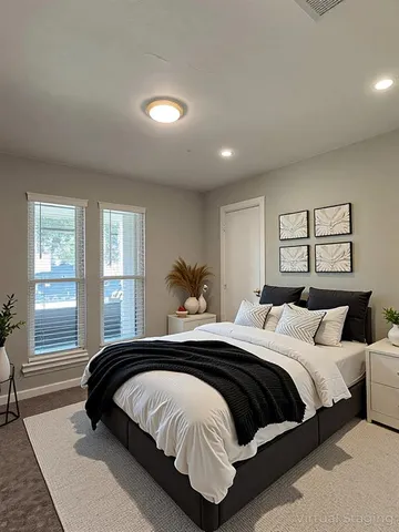 a bedroom with a large bed and a window