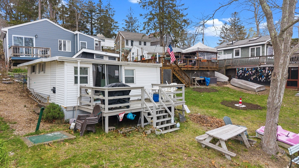 9 F Hideaway Road, Unit 11 Bourne, MA 02532 - Photo 15 of 24 a view of a chairs and table in backyard of the house