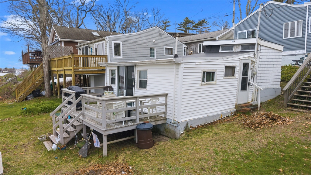 9 F Hideaway Road, Unit 11 Bourne, MA 02532 - Photo 17 of 24 a view of a house with a chairs in patio