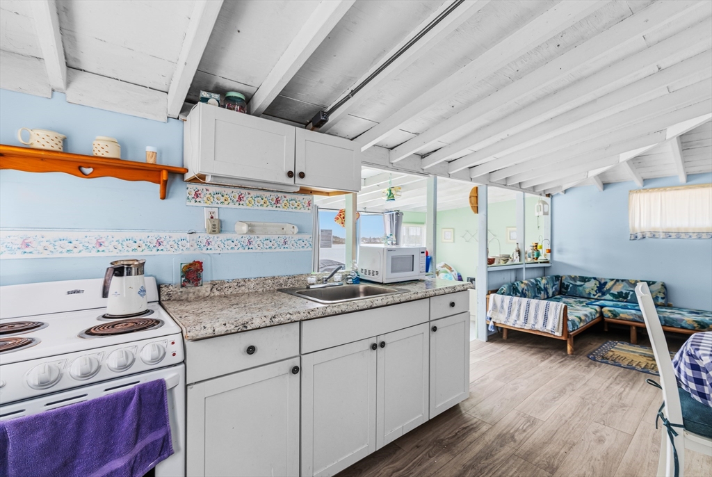 9 F Hideaway Road, Unit 11 Bourne, MA 02532 - Photo 2 of 24 a kitchen with a sink dishwasher cabinets with wooden floor