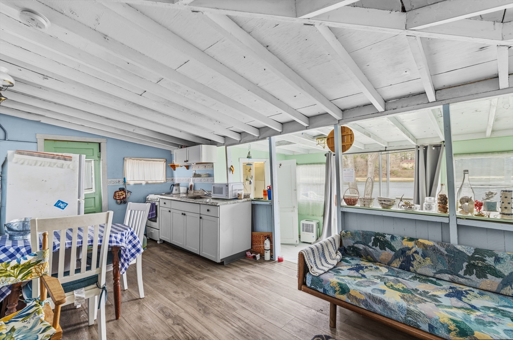 9 F Hideaway Road, Unit 11 Bourne, MA 02532 - Photo 3 of 24 a kitchen with stove and chairs