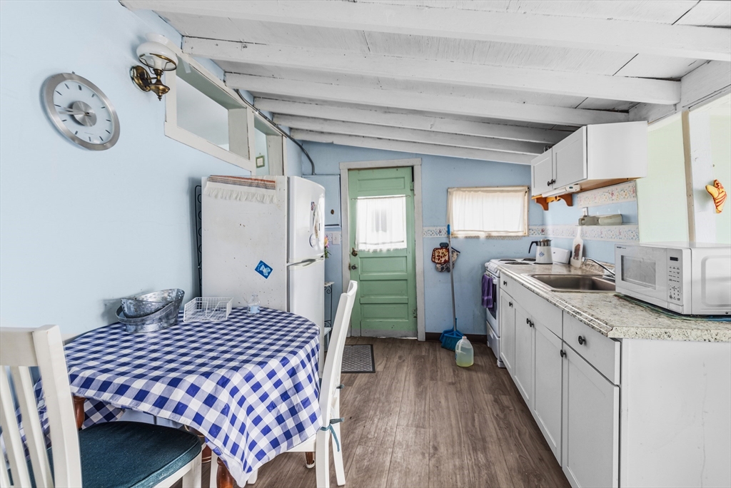 9 F Hideaway Road, Unit 11 Bourne, MA 02532 - Photo 5 of 24 a kitchen with a sink and a refrigerator