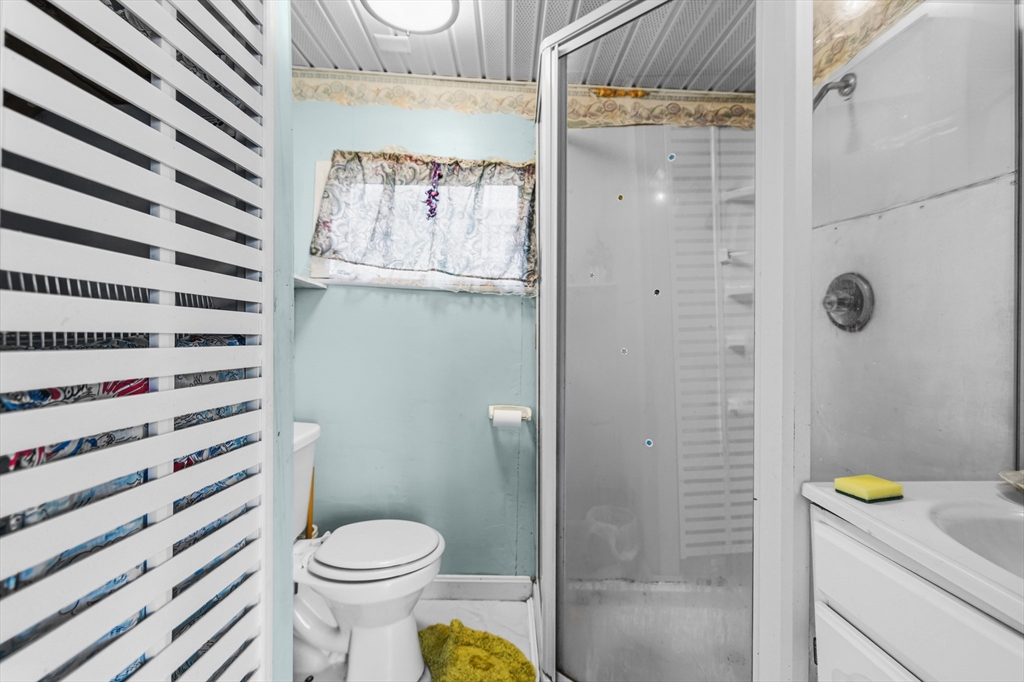 9 F Hideaway Road, Unit 11 Bourne, MA 02532 - Photo 8 of 24 a bathroom with a toilet and a shower