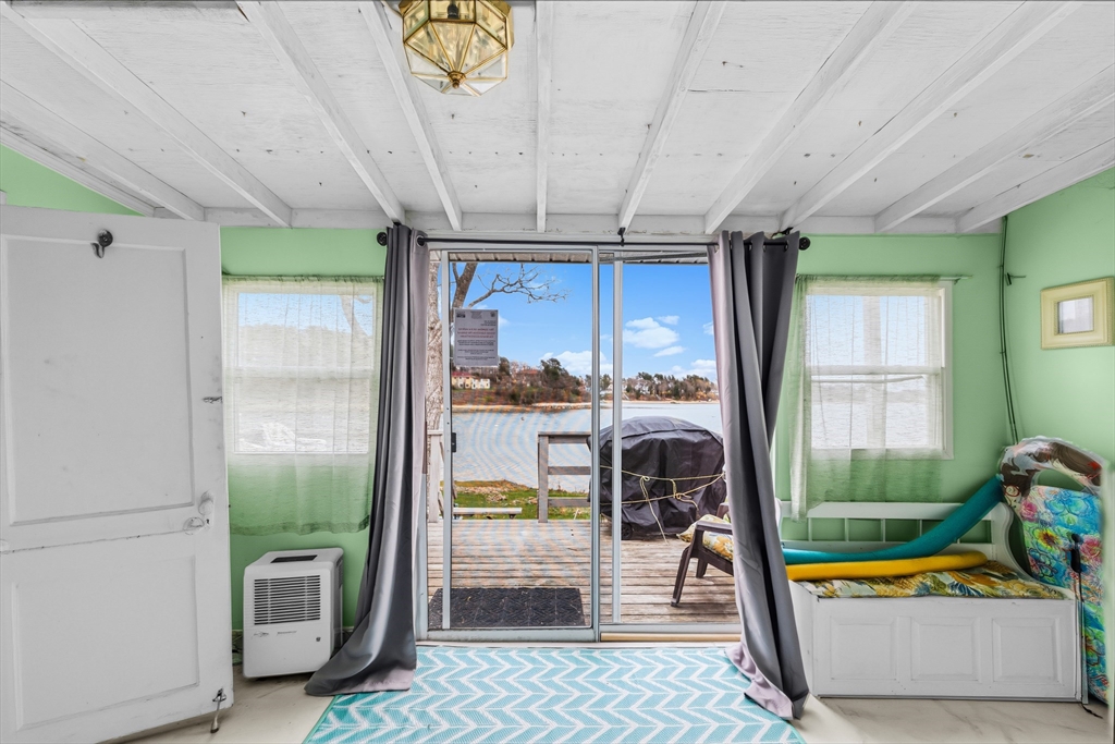 9 F Hideaway Road, Unit 11 Bourne, MA 02532 - Photo 10 of 24 a room with lots of furniture and a large window