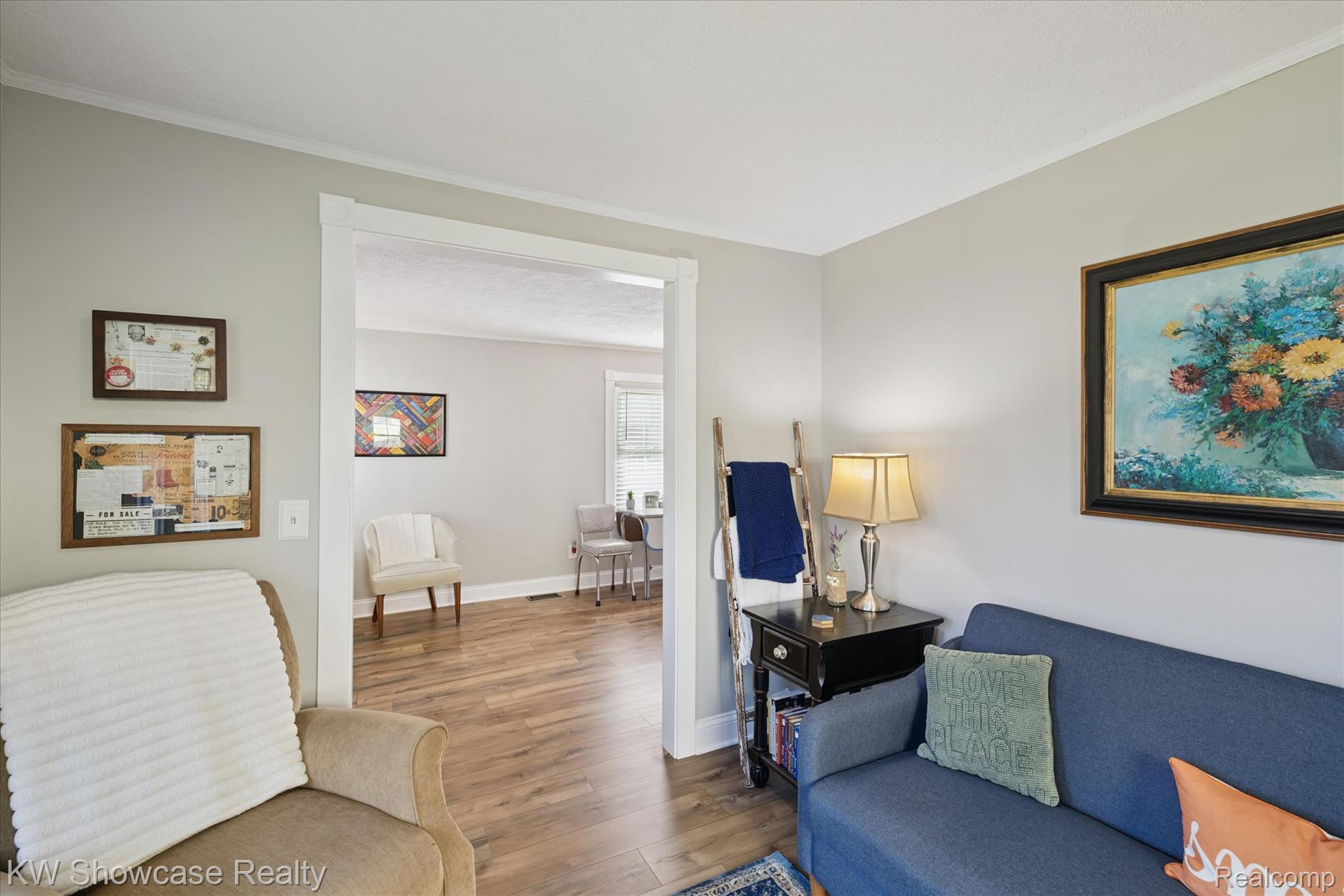 603 West Clinton Street Howell, MI 48843 - Photo 15 of 25 Living room with wood finished floors and ornamental molding