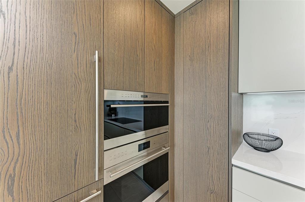 111 Golden Gate Point, Unit 402 Sarasota, FL 34236 - Photo 15 of 79 a kitchen with a stove and a cabinet