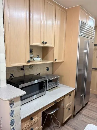 a kitchen with a refrigerator and a sink