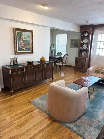 a living room with furniture window and wooden floor