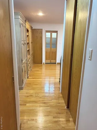 a view of a hallway with wooden floor