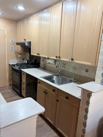 a kitchen with a sink stove and cabinets