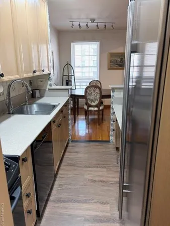 a kitchen with sink refrigerator and window