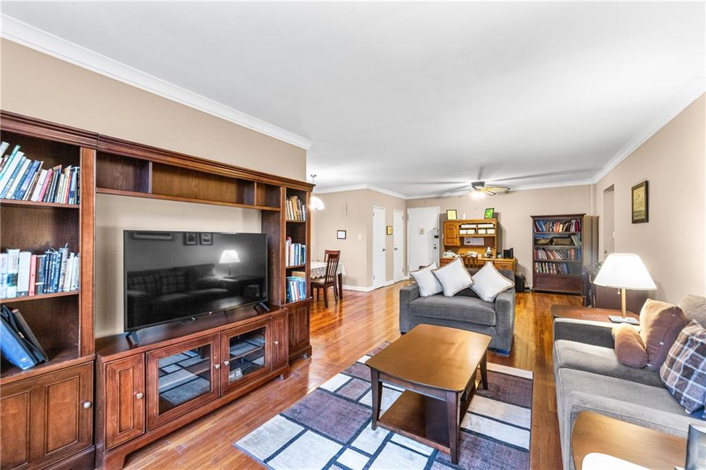 9201 Shore Road, Unit C508 Brooklyn, NY 11209 - Photo 12 of 15 a living room with furniture and a flat screen tv