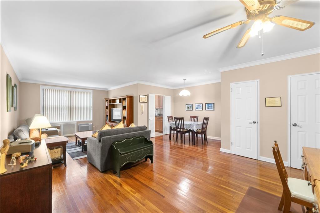 9201 Shore Road, Unit C508 Brooklyn, NY 11209 - Photo 13 of 15 a living room with furniture a dining table and a large window