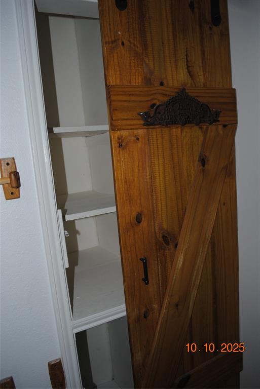 1660 Marsalis Road Lancaster, TX 75146 - Photo 8 of 12 a view of walk in closet with wooden floor