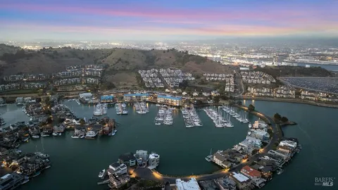 an aerial view of a houses with ocean view