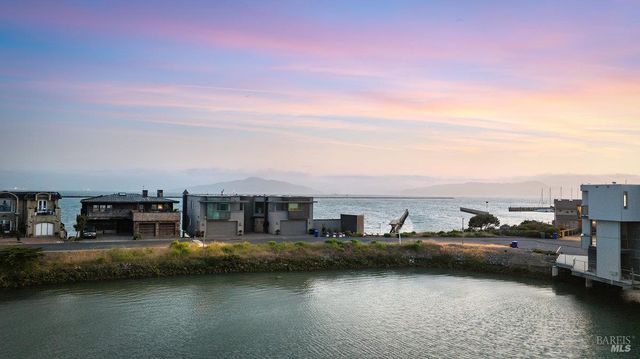 a view of a lake with cars parked