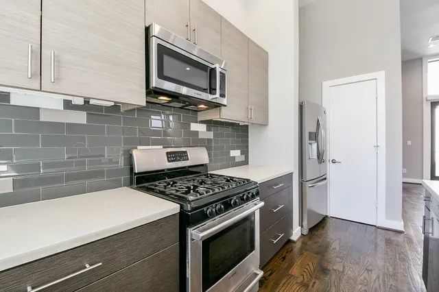 a kitchen with cabinets and steel appliances