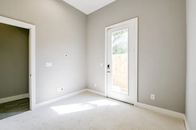 an empty room with windows and closet