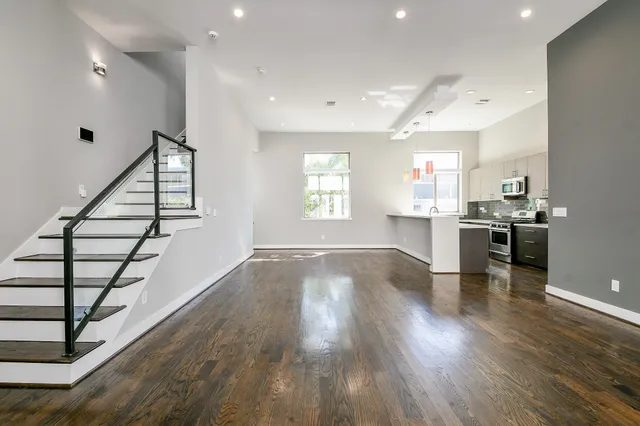 a view of kitchen and hall with wooden floor