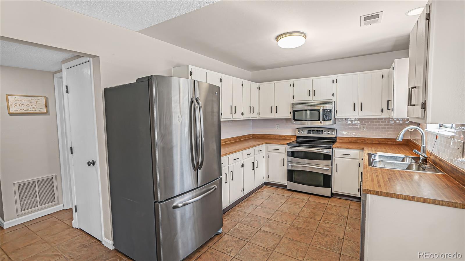 195 Brookside Drive Bailey, CO 80421 - Photo 3 of 24 a kitchen with stainless steel appliances granite countertop a refrigerator stove and sink