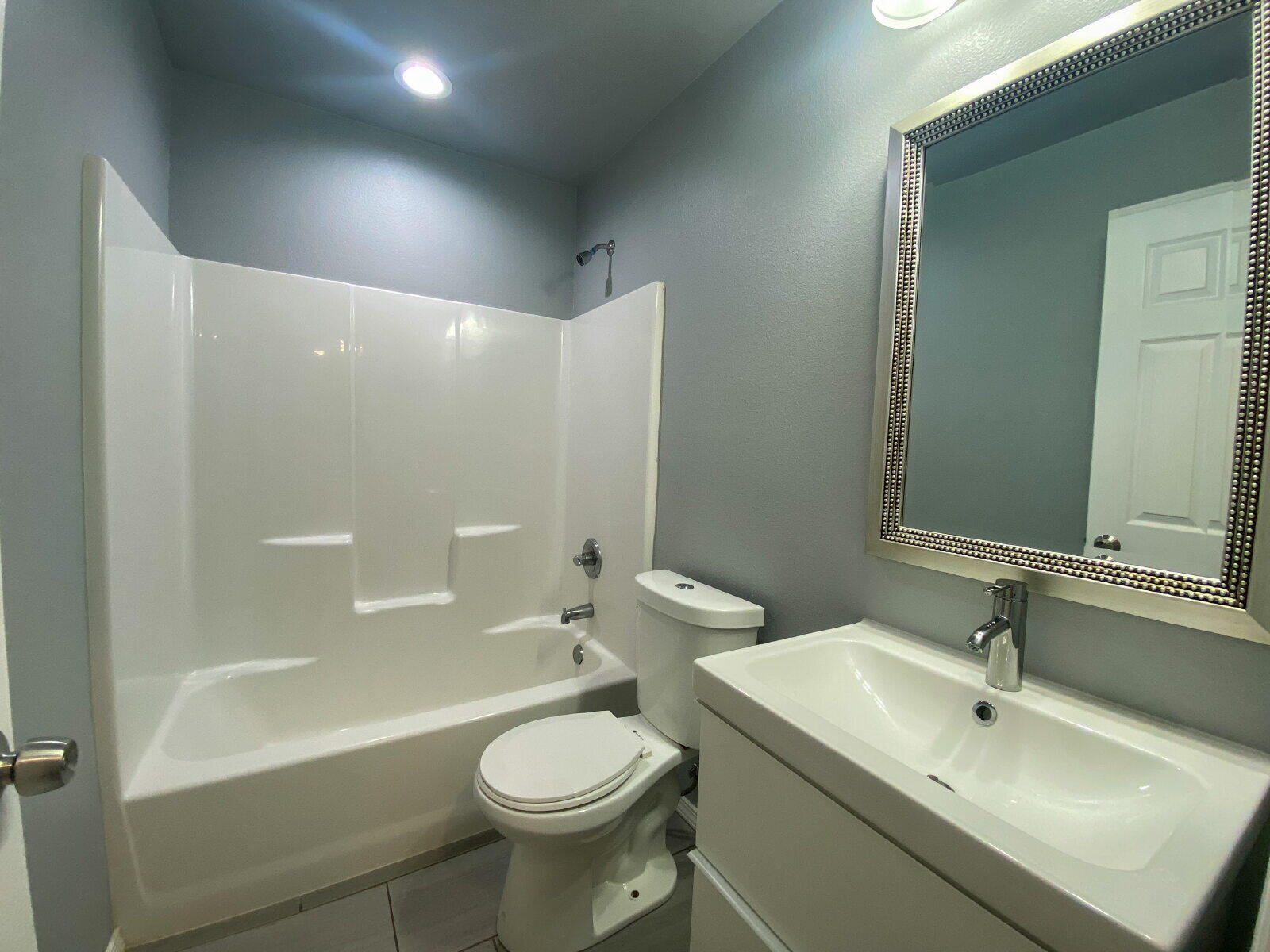 8526 11th Street Lubbock, TX 79416 - Photo 12 of 13 a bathroom with a sink a toilet and shower