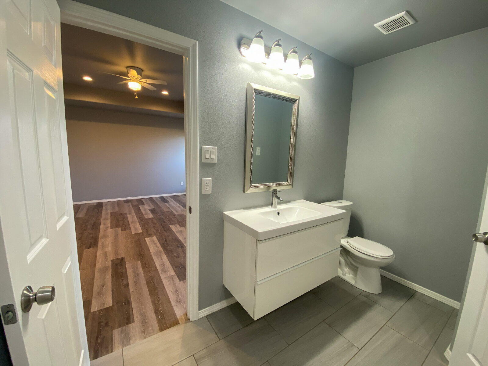 8526 11th Street Lubbock, TX 79416 - Photo 9 of 13 a view of bathroom with a sink and mirror with toilet
