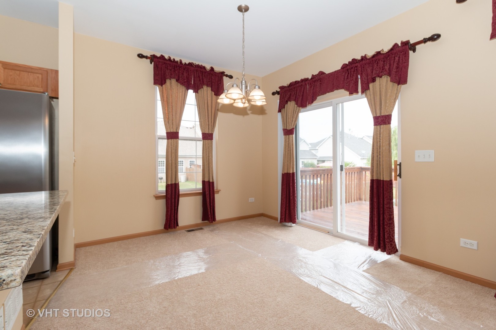545 Maggie Lane Romeoville, IL 60446 - Photo 11 of 23 a view of a big room with windows and chandelier