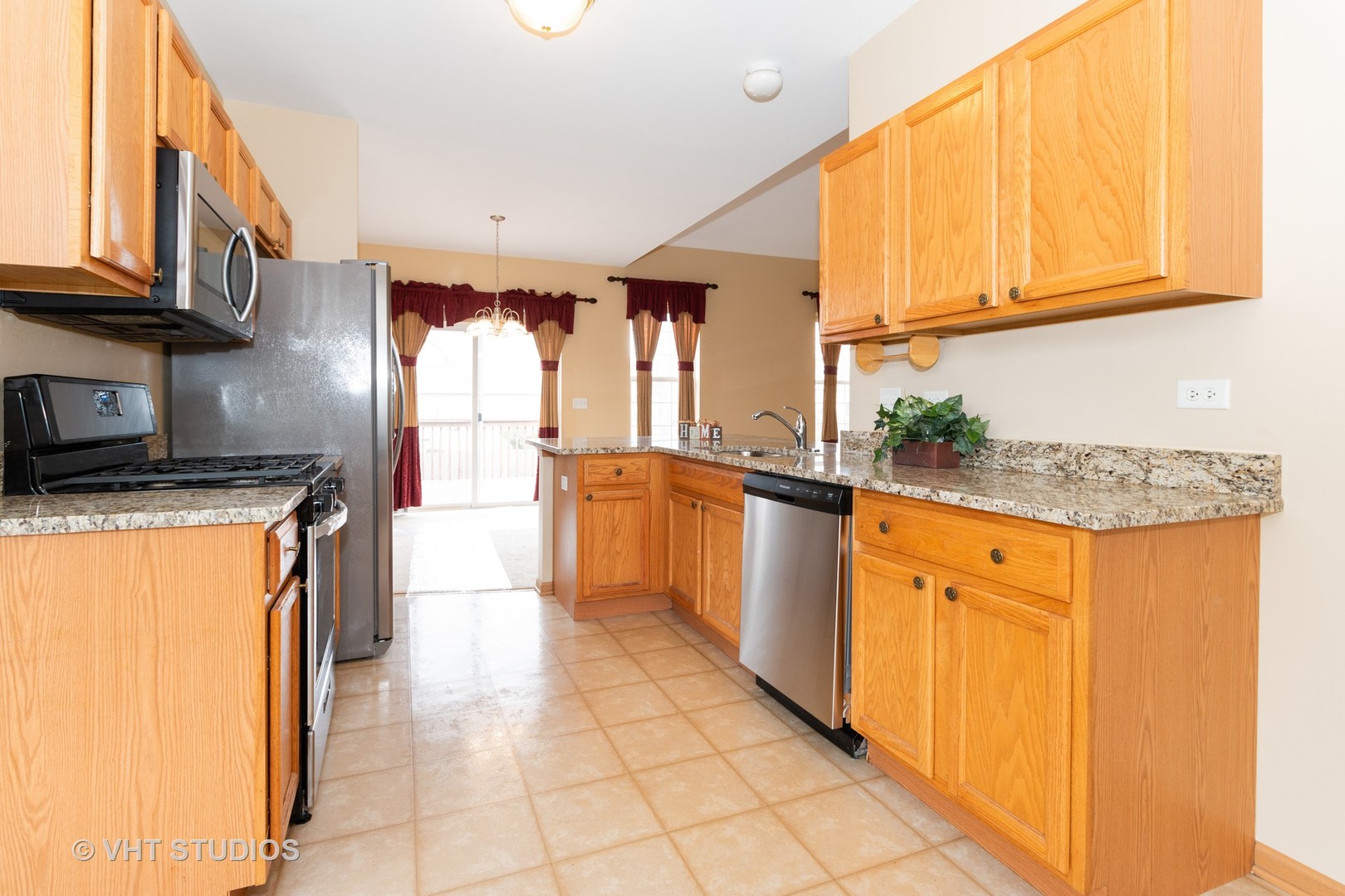 545 Maggie Lane Romeoville, IL 60446 - Photo 5 of 23 a kitchen with stainless steel appliances granite countertop a refrigerator and a stove top oven