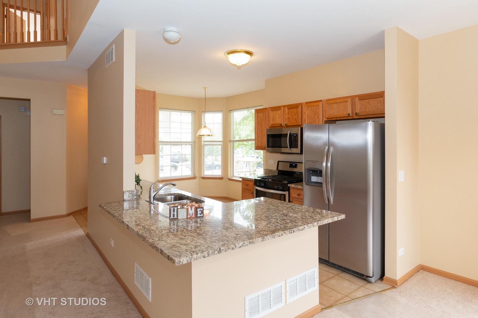 545 Maggie Lane Romeoville, IL 60446 - Photo 7 of 23 a kitchen with granite countertop a sink a refrigerator and a granite counter tops