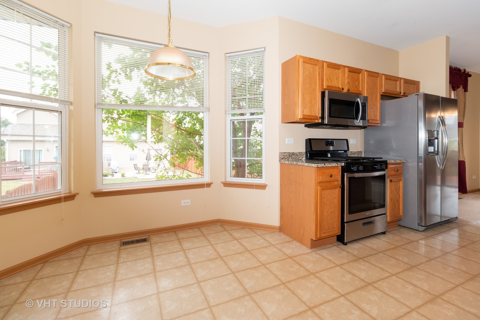 545 Maggie Lane Romeoville, IL 60446 - Photo 8 of 23 a kitchen with stainless steel appliances a stove a sink and a refrigerator