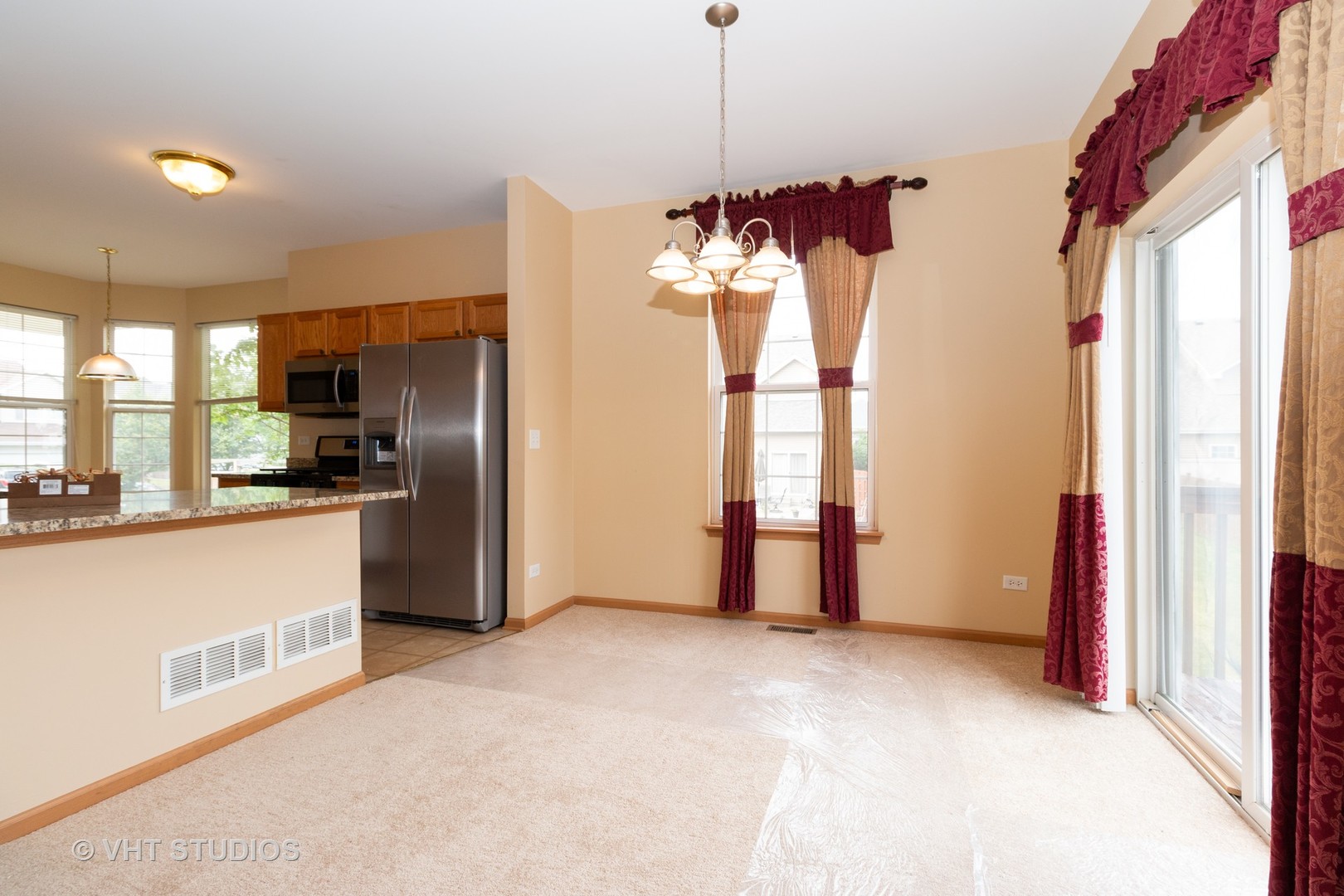 545 Maggie Lane Romeoville, IL 60446 - Photo 10 of 23 a view of a kitchen with a stove and refrigerator