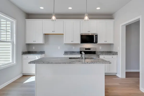 a kitchen with appliances a sink and a stove