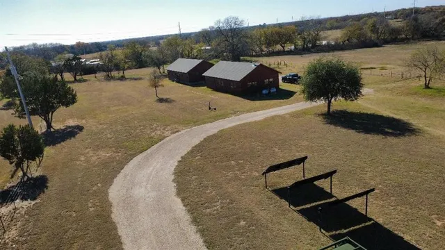an aerial view of a house with a yard