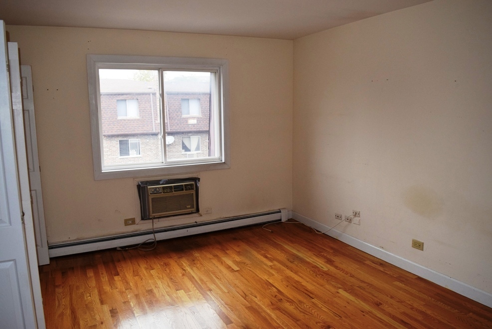 10473 Dearlove Road, Unit 6 Glenview, IL 60025 - Photo 13 of 21 an empty room with wooden floor and windows