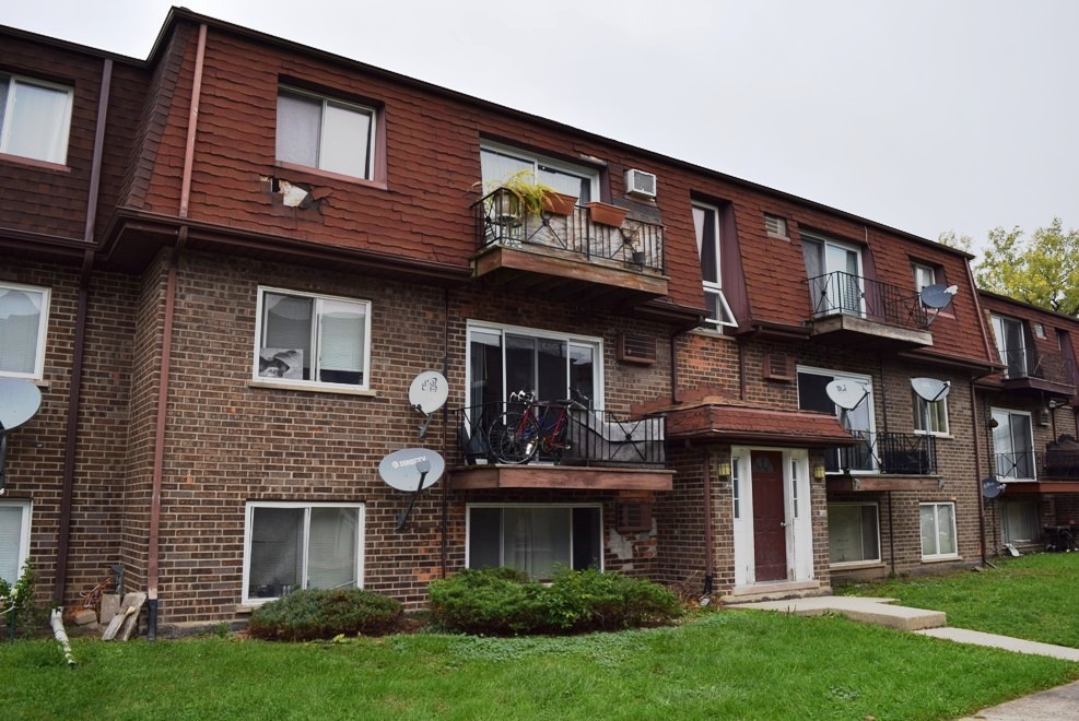 10473 Dearlove Road, Unit 6 Glenview, IL 60025 - Photo 17 of 21 a front view of a brick building with a yard