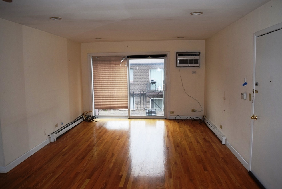 10473 Dearlove Road, Unit 6 Glenview, IL 60025 - Photo 4 of 21 an empty room with wooden floor and windows