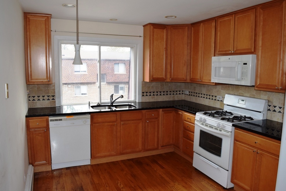 10473 Dearlove Road, Unit 6 Glenview, IL 60025 - Photo 7 of 21 a kitchen with stainless steel appliances granite countertop a stove a sink and a microwave