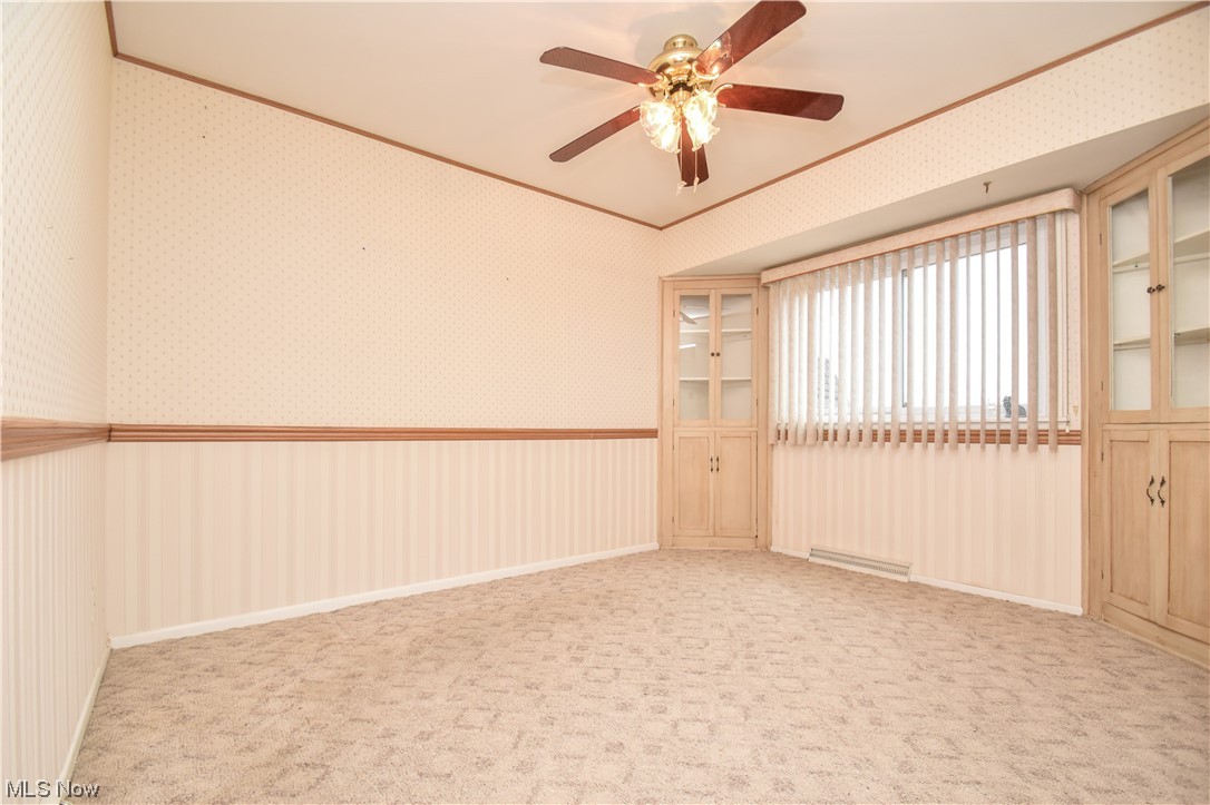 4606 Burkey Road Youngstown, OH 44515 - Photo 17 of 49 Unfurnished room featuring baseboard heating, ceiling fan, and light colored carpet