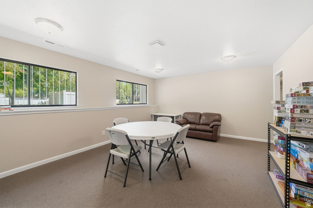 6969 South 855 East Midvale, UT 84047 - Photo 48 of 55 Spacious room featuring neutral wall paint, recessed lighting, carpet flooring, and multiple windows