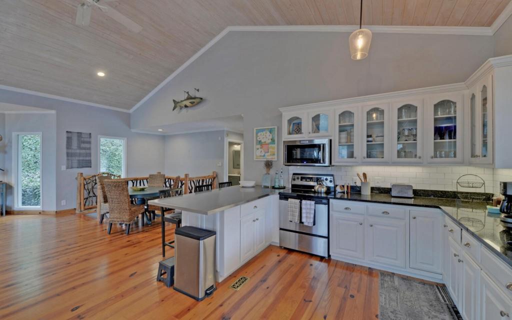 1431 Tame Turkey Road Lakemont, GA 30552 - Photo 11 of 62 a large white kitchen with lots of counter space a sink and appliances