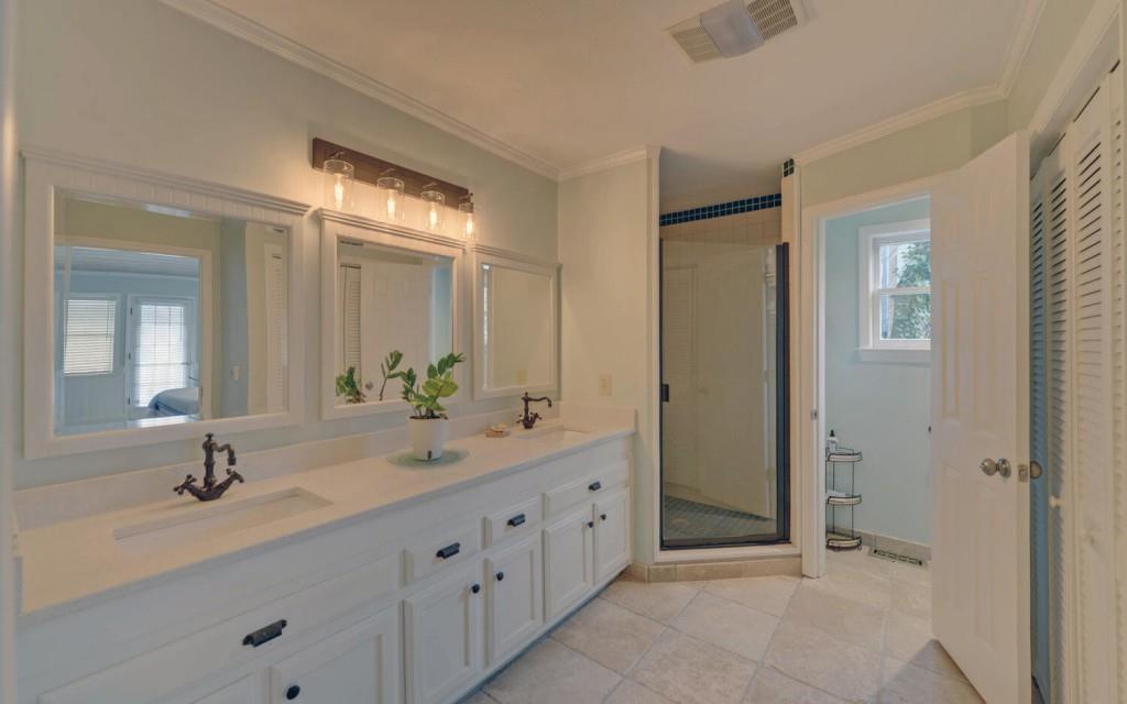 1431 Tame Turkey Road Lakemont, GA 30552 - Photo 15 of 62 a bathroom with a double vanity sink and mirror