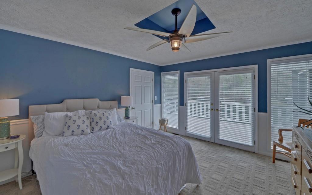 1431 Tame Turkey Road Lakemont, GA 30552 - Photo 18 of 62 a bedroom with a large bed and a ceiling fan
